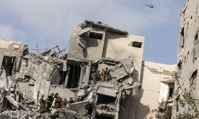 Israeli emergency services and security officers search for casualties in the rubble of a building hit by an Iranian missile in Beersheba in southern Israel. &mdash; AFP