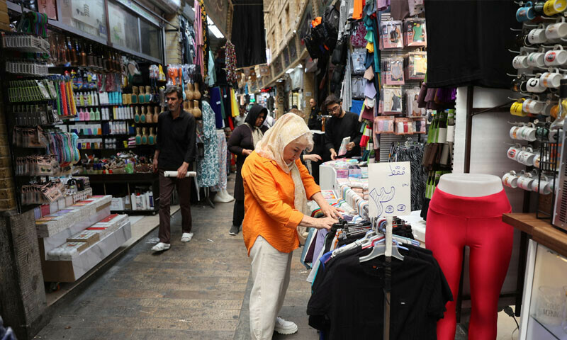 An Iranian woman shops in Tajrish Bazaar in Tehran &mdash; Reuters