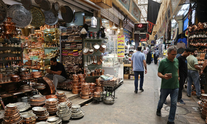 People walk in the Tajrish Bazaar in Tehran &mdash; Reuters