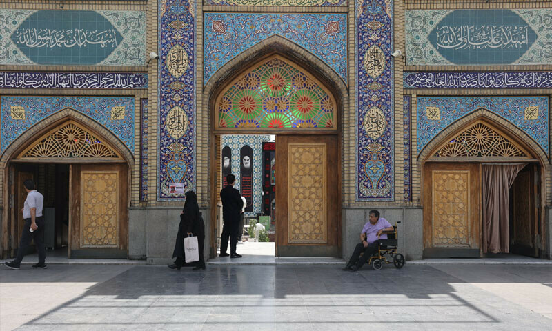 People walk in front of the Imamzadeh Saleh holy shrine in northern Tehran, after the ceasefire between Iran and Israel, in Tehran, Iran, June 26, 2025. &mdash; Reuters