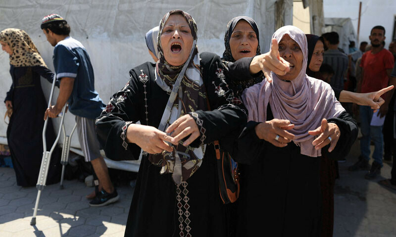 Palestinian women react upon the arrival of their relatives among the casualties of an Israeli air strike at Al-Ahli Arab Hospital in Gaza City. — Reuters