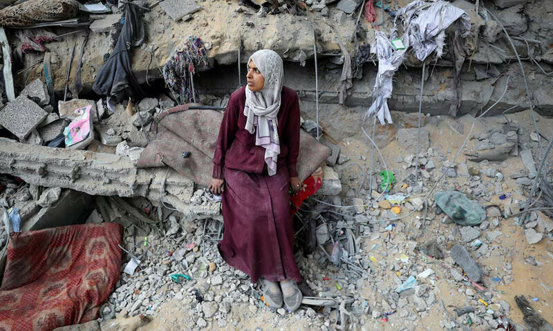  A Palestinian woman sits amidst the damage at an UNRWA school sheltering displaced people that was hit in an Israeli air strike on Sunday, in Gaza City on June 30. &mdash; Reuters 