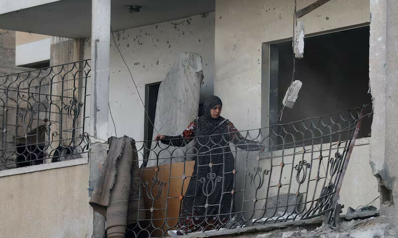  Palestinian woman looks at the damage, at the site of an Israeli strike on a house that took place on Monday, in Zawayda in the central Gaza Strip on July 1, 2025. &mdash; Reuters 
