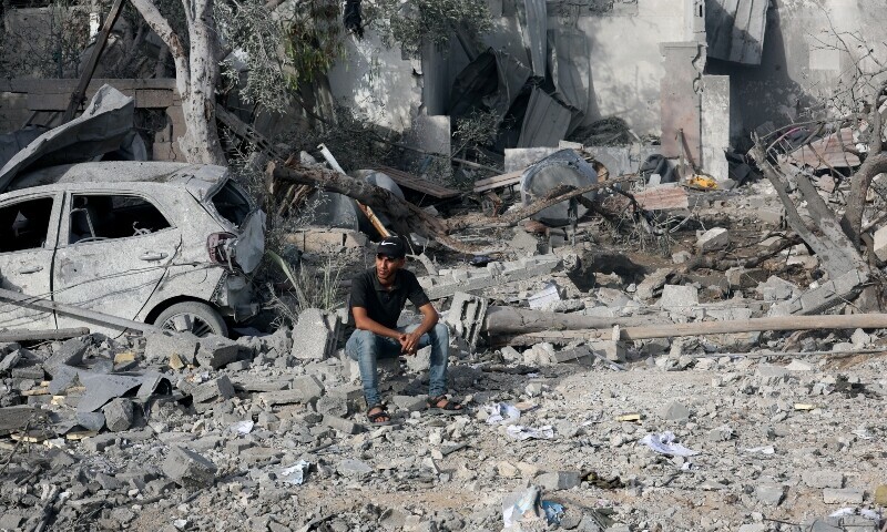 A Palestinian man sits at the site of an Israeli strike on a house that took place a day earlier, in Zawayda in the central Gaza Strip. — Reuters