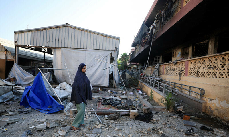 A Palestinian inspects the damage at a school sheltering displaced people following an overnight Israeli airstrike in Gaza on July 3, 2025. &mdash; Reuters