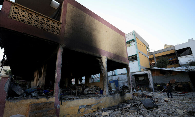 A Palestinian girl looks at the damage at a school sheltering displaced people following an overnight Israeli airstrike in Gaza on July 3, 2025. &mdash; Reuters