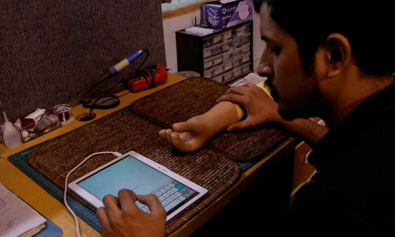 A technician checks a prosthetic limb at the Bioniks in Karachi, April 29, 2024. — Reuters