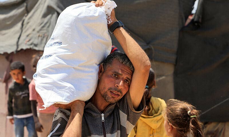 A Palestinian carries an aid supply he received from the US-backed Gaza Humanitarian Foundation, in Khan Younis, in the southern Gaza Strip on May 28, 2025. — Reuters