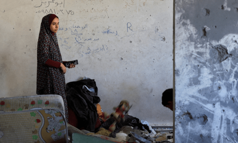 A Palestinian woman looks on at the site in the aftermath of an overnight Israeli strike on Al-Remal clinic where displaced people take shelter, in Gaza City on July 7, 2025. — Reuters
