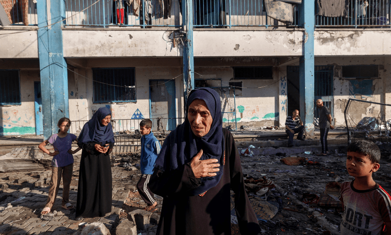  A Palestinian woman reacts as she checks the damages after an Israeli strike which hit a school sheltering displaced Palestinians in the Al-Bureij camp in the central Gaza Strip on July 8, 2025. &mdash; AFP 