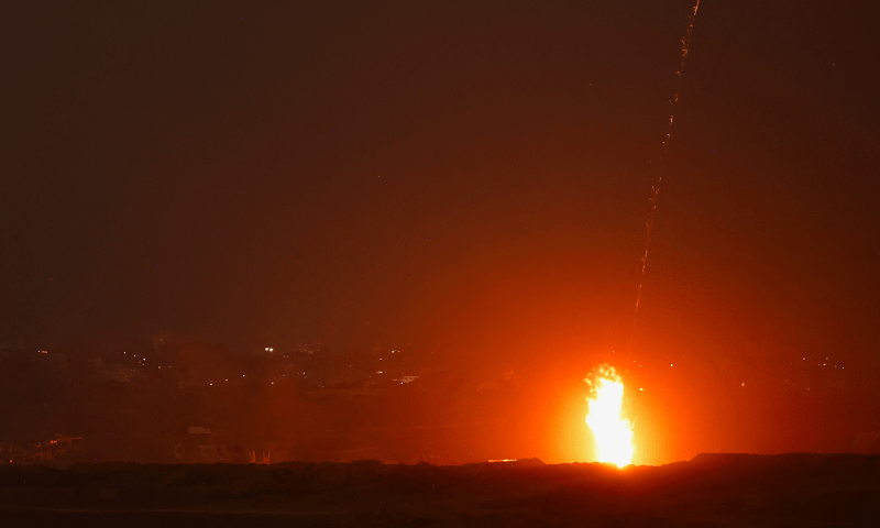  A beam of light is seen resulting from an explosion, as seen from the Israeli side of the Israel-Gaza border on July 10, 2025. &mdash; Reuters 