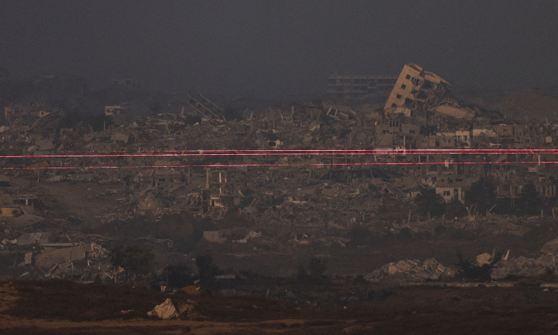  Beams of light are seen from the Israeli side of the Israel-Gaza border on July 10, 2025. &mdash; Reuters 