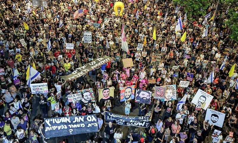 Demonstrators gather during an anti-government protest calling for action to secure the release of Israeli hostages held captive in the Gaza Strip by Hamas since the 2023 October 7 attacks, outside the Israeli Defence Ministry headquarters in Tel Aviv on July 12, 2025. &mdash; AFP