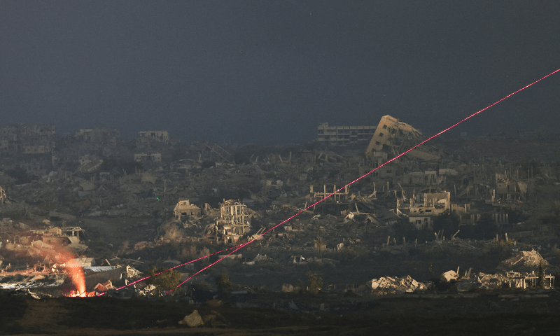  A view shows beams of light in Gaza, as seen from the Israeli side of the Israel-Gaza border on July 13, 2025. — Reuters 