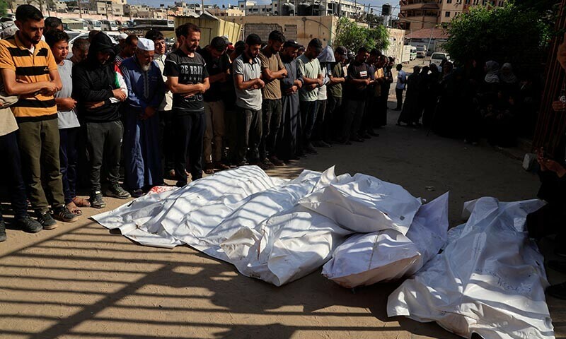 Mourners pray next to the bodies of Palestinians killed in morning Israeli strikes on tents sheltering displaced people, according to medics, during their funeral at Nasser Hospital in Khan Younis, southern Gaza Strip on July 14. — Reuters