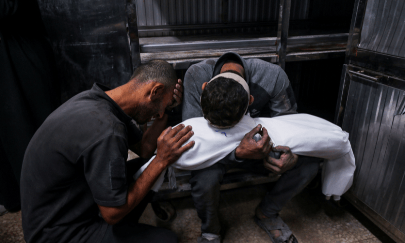  Hossam Azzam holds the body of his son Ameer, a Palestinian child killed in an overnight Israeli strike on a house, according to medics, at Al-Shifa hospital in Gaza City on July 15, 2025. — Reuters 
