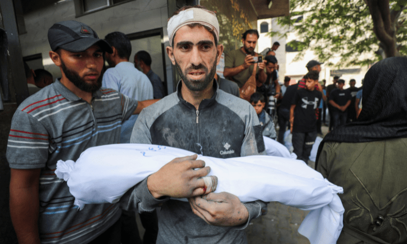  Hossam Azzam carries the body of his son Ameer, a Palestinian child killed in an overnight Israeli strike on a house, according to medics, at Al-Shifa hospital in Gaza City on July 15, 2025. — Reuters 