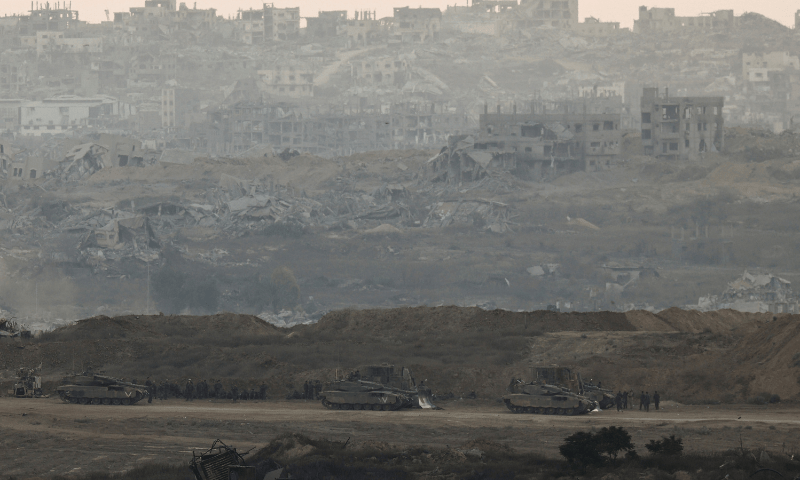  Israeli soldiers stand near tanks in Gaza, as seen from the Israeli side of the Israel-Gaza border on July 20, 2025. &mdash; Reuters 