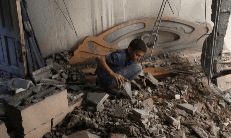  A Palestinian boy inspects the site of an overnight Israeli air strike on a house in Gaza City on July 23, 2025. &mdash; Reuters 