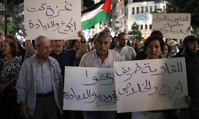  Palestinians chant slogans and carry placards during a demonstration in support of Palestinians in Gaza facing severe shortages of food and other essentials in the city of Ramallah in the Israeli-occupied West Bank on July 23, 2025. &mdash; AFP 