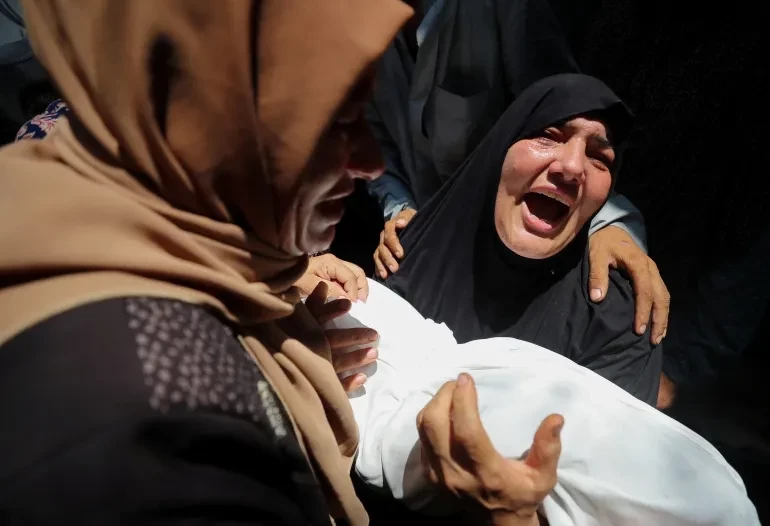 The grandmother of Qais Adwan, who was killed in an Israeli strike on a school sheltering displaced people, according to medics, mourns at Al-Shifa Hospital in Gaza City, July 25. — Reuters
