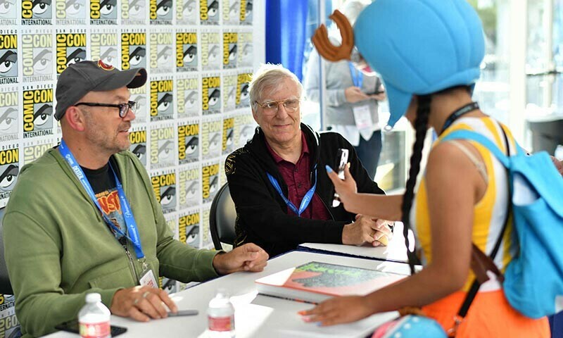 Authors Steve Ryfle and Ed Godziszewski speak with a young fan at the signing of their book ’Godzilla: The First 70 Years during Comic Con International in San Diego, California, US on July 26. — AFP