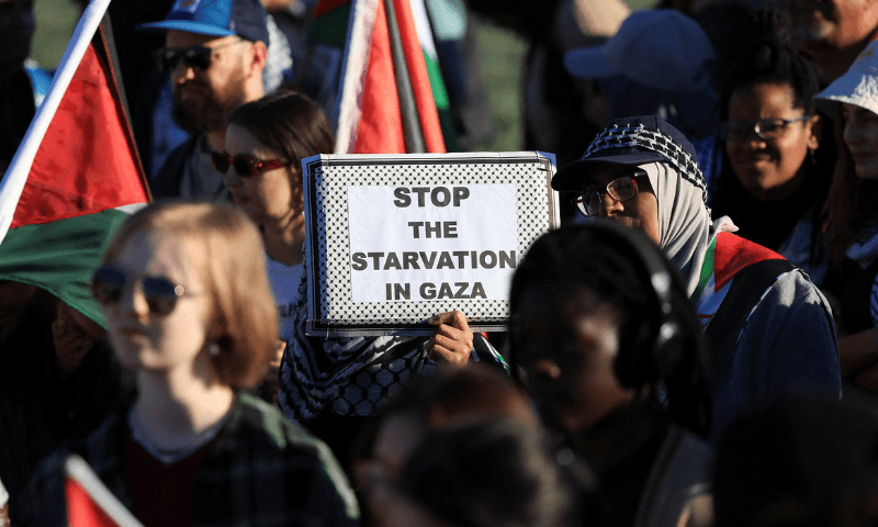  A pro-Palestinian activist holds a placard as they protest over hunger crisis in Gaza, along Sea Point Promenade in Cape Town, South Africa on July 27, 2025. &mdash; Reuters 