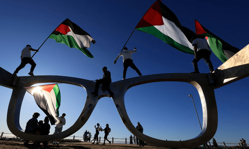  Pro-Palestinian activists hold Palestinian flags as they protest over hunger crisis in Gaza, along Sea Point Promenade in Cape Town, South Africa on July 27, 2025. &mdash; Reuters 