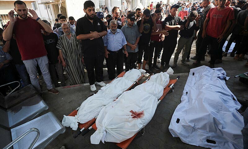 Mourners stand next to the bodies during the funeral of Palestinians, who were killed by Israeli fire while trying to receive aid on Monday, and Palestinians who were killed in an overnight Israeli strikes, according to medics, at Al-Shifa Hospital in Gaza City, July 29, 2025. — Reuters