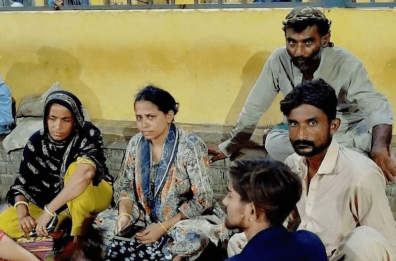 Najma (centre), Sonya (wearing yellow on Najma’s left), and their brother (on Najma’s right) were sitting on the pavement outside the trauma center where Shanti was fighting for her life. Credit: Seema Maheshwari