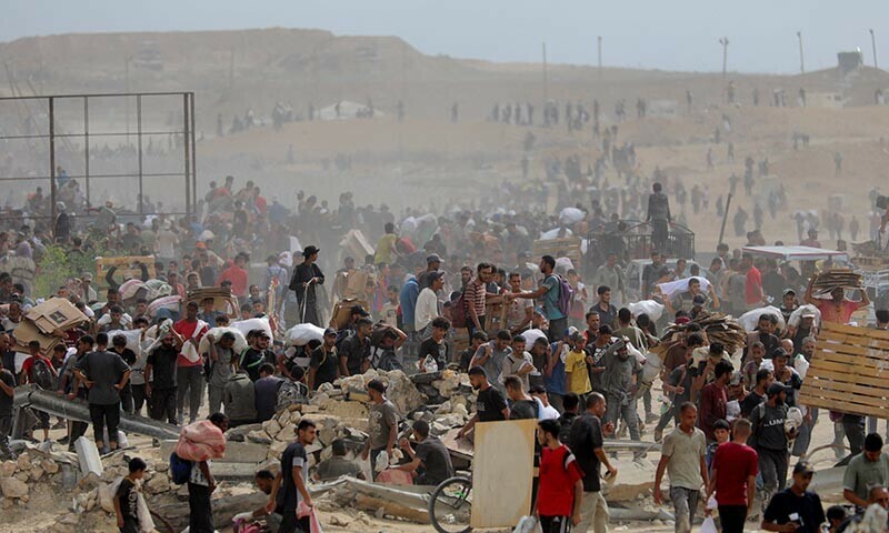 Palestinians carry aid supplies which they received from the US-backed Gaza Humanitarian Foundation, in the central Gaza Strip, August 1, 2025. — Reuters