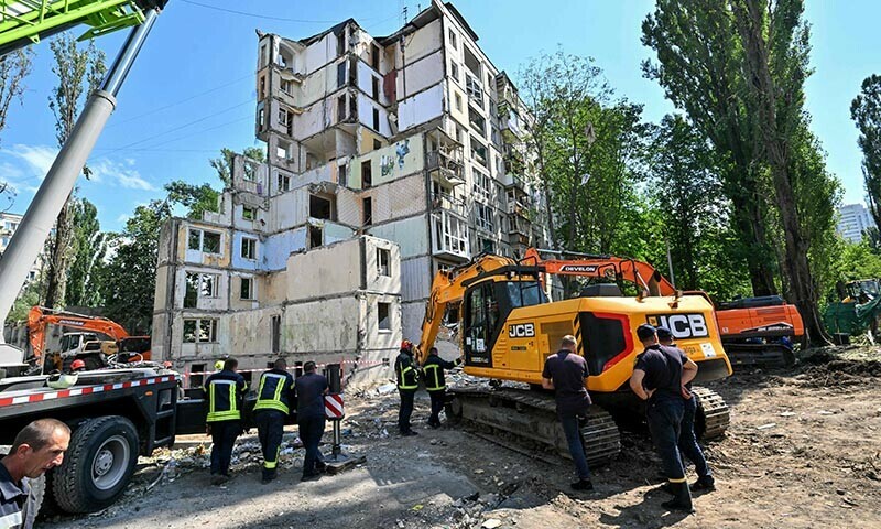 Rescuers work outside a residential building in Kyiv, Ukraine on August 1, which was partially destroyed following a Russian missile strike morning on July 31. — AFP