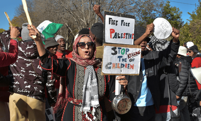  An activist holds placards during a protest over the hunger crisis in Gaza and in solidarity with Palestinians, outside United Arab Emirates embassy in Pretoria, South Africa on August 1, 2025. &mdash; Reuters 