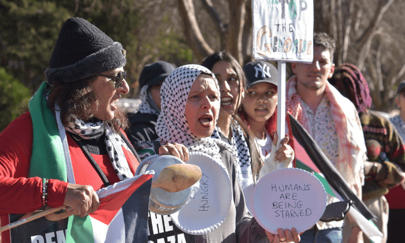  Activists hold placards during a protest over the hunger crisis in Gaza and in solidarity with Palestinians, outside United Arab Emirates embassy in Pretoria, South Africa on August 1, 2025. &mdash; Reuters 