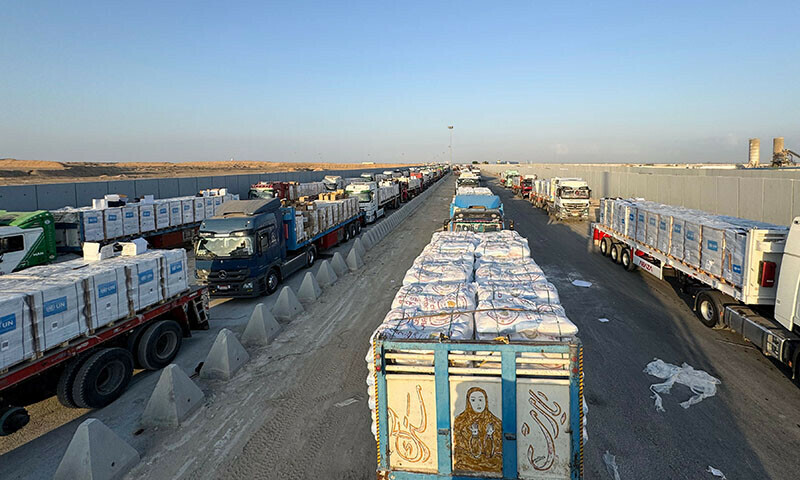  Trucks loaded with humanitarian aid await permission on the Egyptian side of the Rafah crossing with the Gaza Strip, to drive toward the besieged Palestinian territory on August 3. &mdash; AFP 