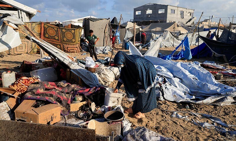 Palestinians inspect the damage at the site of an overnight Israeli strike on a tent sheltering displaced people, in Khan Younis, southern Gaza Strip on August 5, 2025. &mdash; Reuters