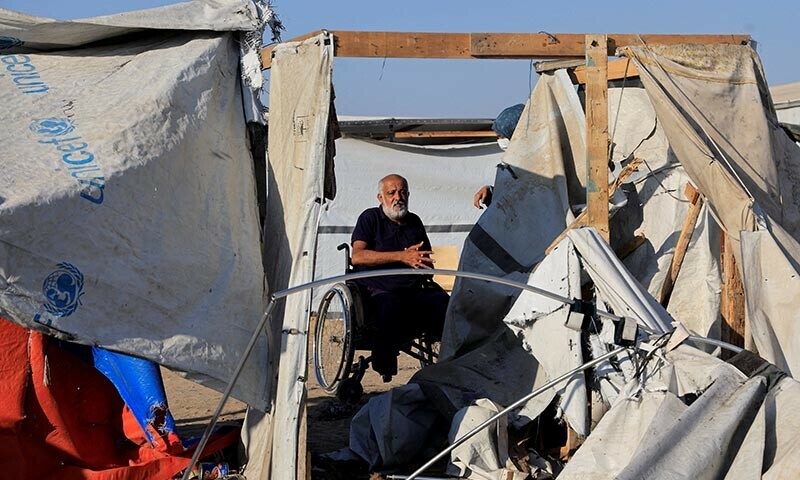Palestinians inspect the damage at the site of an overnight Israeli strike on a tent sheltering displaced people, in Khan Younis, southern Gaza Strip on August 5, 2025. &mdash; Reuters