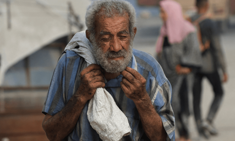 A palestinian man carries aid supplies he collected from trucks that entered Gaza through Israel, in Beit Lahia, in the northern Gaza Strip on August 10, 2025.  &mdash; Reuters 