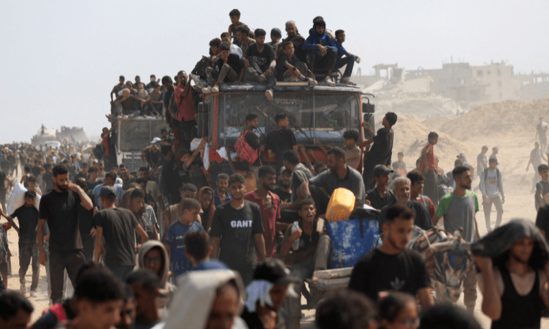  Palestinians seek aid supplies from trucks that entered Gaza through Israel, in Beit Lahia, in the northern Gaza Strip on August 10, 2025. &mdash; Reuters 