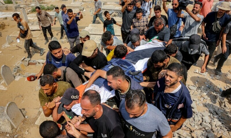 Mourners carry one of the bodies of the <em>Al Jazeera</em> journalists who were killed in an overnight Israeli strike on their tent in Gaza City, during the burial at the Sheikh Radwan cemetery in Gaza City on August 11. &mdash; AFP