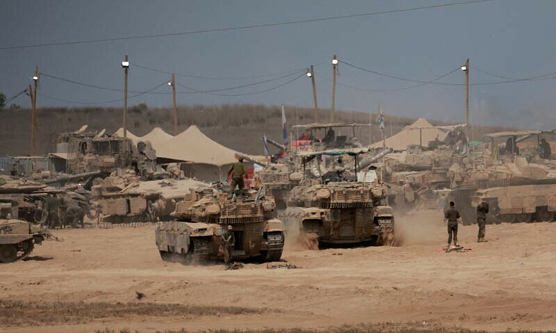 A view shows military vehicles on the Israeli side of the border with Gaza, as seen from Israel, August 12, 2025. &mdash; Reuters