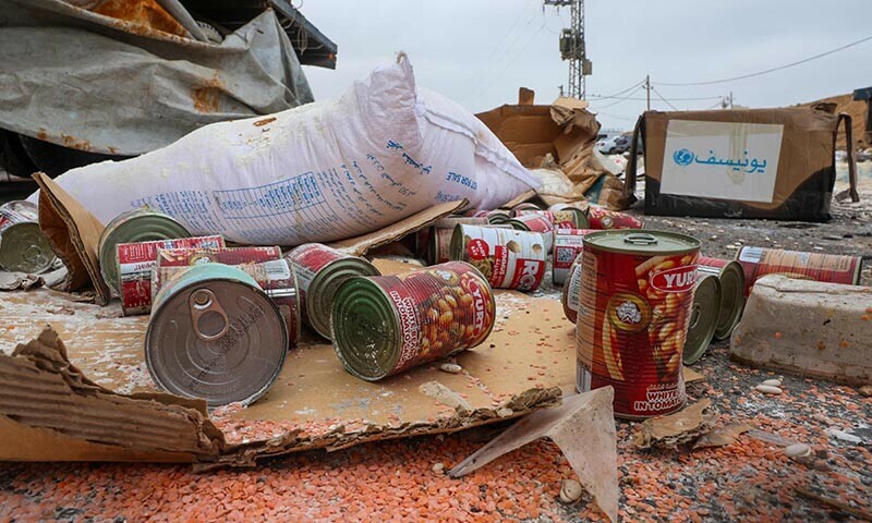 Damaged humanitarian aid for Palestinians in Gaza lies scattered on the ground next to broken-down trucks near the border with the Gaza Strip, close to the Kissufim crossing in southern Israel, on August 13, 2025. &mdash; AFP