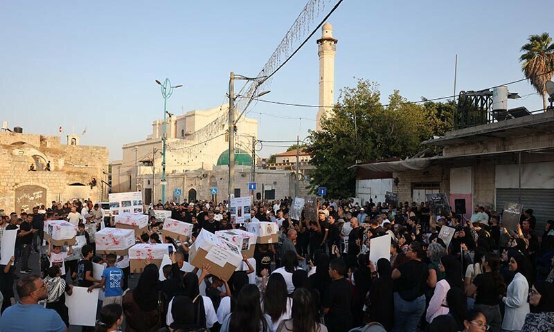 Israeli Arab children carry boxes depicting children&rsquo;s coffins on August 16, 2025, as people protest in the city of Lod near Tel Aviv, to denounce food shortages in the Gaza Strip and the ongoing war on the Palestinian territory. &mdash; AFP