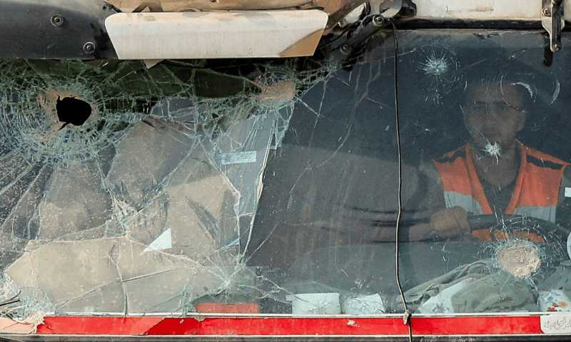 A driver sits inside a truck carrying aid supplies that entered through Israel as Palestinians scramble to collect them, in Khan Younis, southern Gaza Strip, on August 12, 2025. — Reuters