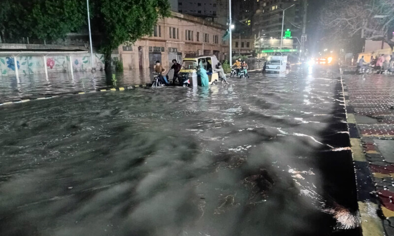  آئی آئی چندریگر روڈ اور ڈاکٹر ضیا الدین روڈ کے سنگم پر رات دیر گئے تک بھی سڑک دریا کا منظر پیش کرتی رہی، شہری خراب گاڑیاں اور موٹرسائیکل چھوڑ کر چلے گئے&mdash;فوٹو: عثمان احمد خان 