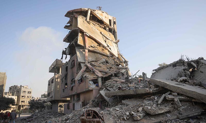 Palestinians gather at the site of Israeli air strikes on a six-storey building in the Saftawi neighborhood west of Jabalia in the northern Gaza Strip on August 19, 2025. &mdash; AFP
