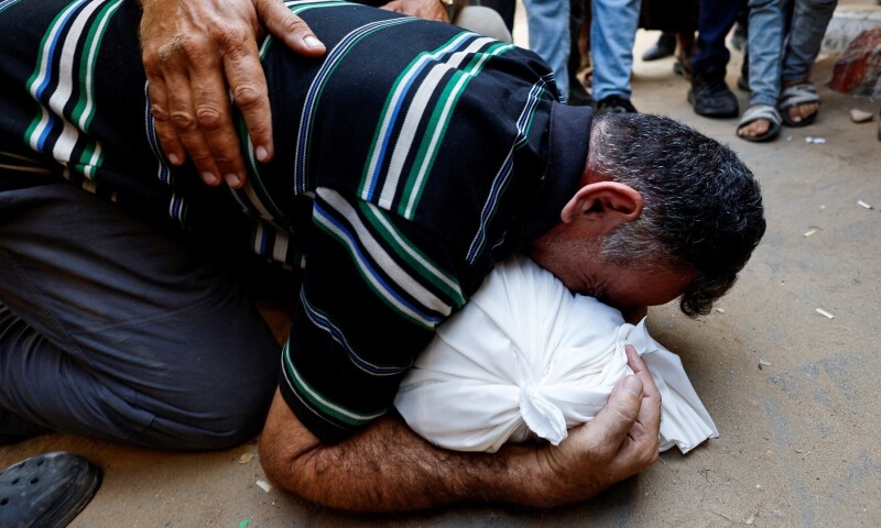  Palestinian father Mahmoud Abedrabo mourns over the body of his son Hamada, who was killed in an Israeli strike, according to medics, at Al-Shifa Hospital in Gaza City on Aug 24, 2025. &mdash; Reuters/Mahmoud Issa 