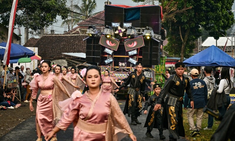 This photo taken on August 9, 2025, shows dancers performing as they follow a truck mounted with a tower of subwoofers and spotlights during a “sound horeg”, which loosely means to move or vibrate in Javanese, held as part of Indonesia’s 80th Independence Day celebrations in Malang, East Java. — AFP