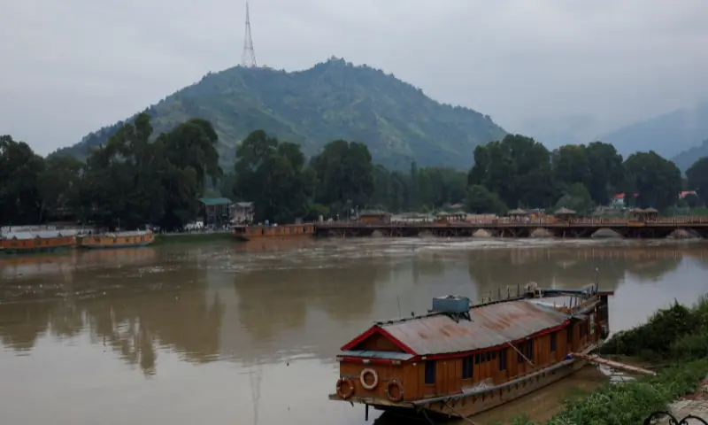A view of a houseboat on the overflowing Jhelum River following heavy rain, in Srinagar, Indian-occupied Kashmir, on August 27. — Reuters