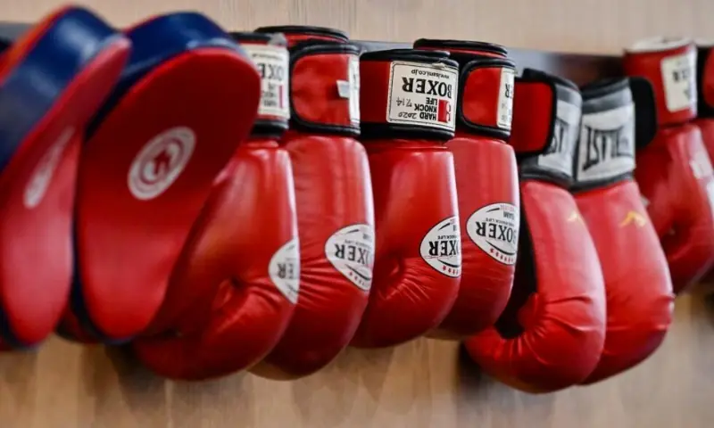 This photo taken on September 22, 2022 shows boxing gloves hanging on the wall of a gym. &mdash; AFP/File